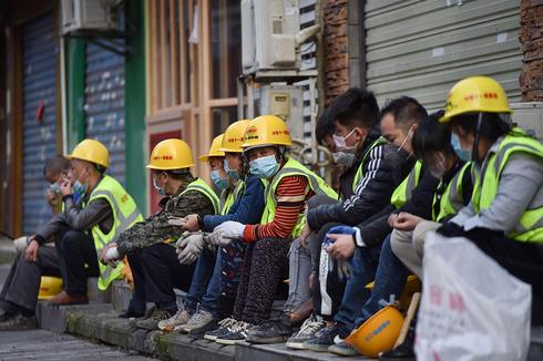 Trabajadores con máscaras contra el coronavirus en Wuhan, China