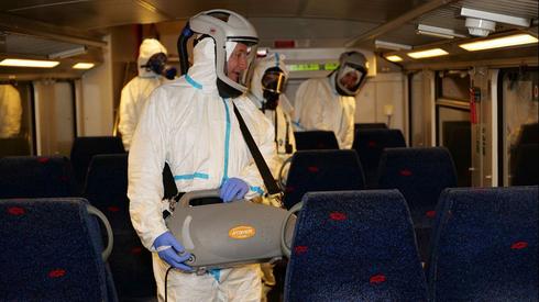 Trabajadores de la salud desinfectan un tren de Israel Railways