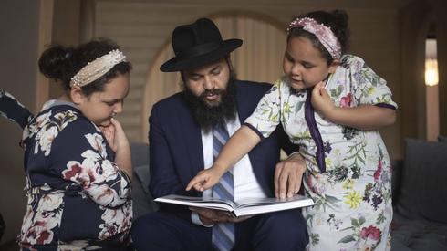 El rabino Levi Banon y sus hijas leen un libro 