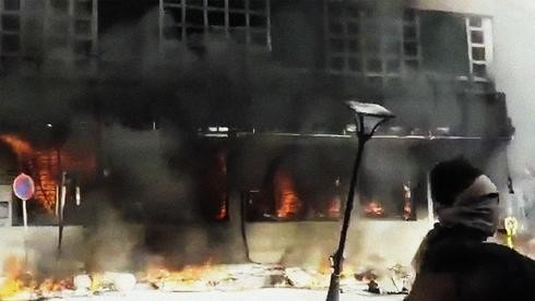 Un banco arde en llamas durante las protestas en Irán a fines del 2019.