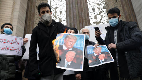 Manifestantes iraníes prenden fuego imágenes de Joe Biden y Donald Trump.