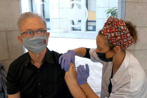 Uno de los primeros vacunados recibe su dosis en una clínica del centro de Israel. 