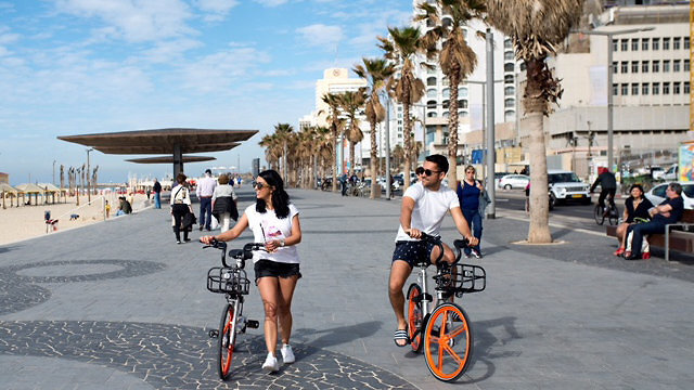 Ciudadanos israelíes pasean en bicicleta por Tel Aviv. 