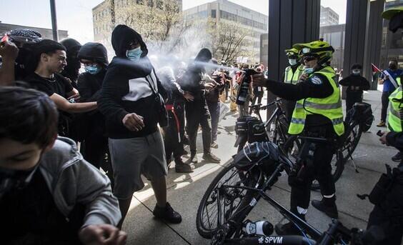 Un policía arroja gas pimienta a los protestantes propalestina en Canadá. 