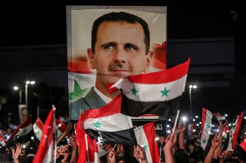 Partidarios de Asad celebran el resultado electoral. 