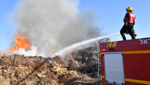 Un bombero combate el fuego causado por un globo incendiario. 