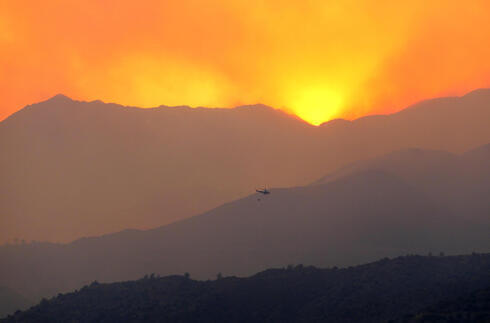 Un helicóptero sobrevuela un incendio forestal, en la región montañosa de Larnaca, Chipre