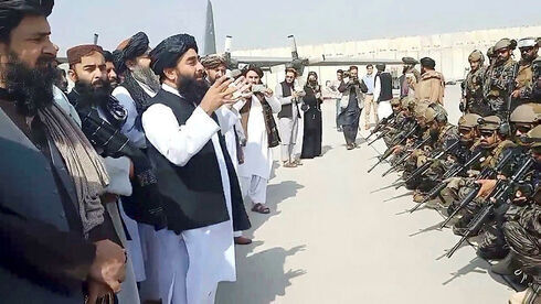 El portavoz del Talibán, Zabihullah Mujahid, brinda un discurso frente a las tropas del grupo islamista en el aeropuerto de Kabul el martes tras la retirada del ejército estadounidense.