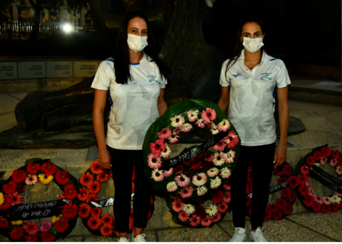 Deportistas israelíes colocan una de las coronas de flores. 