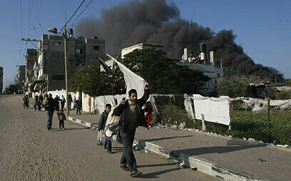 Gazatíes que protestaban, en 2009, contra los ataques de Israel. De fondo, el humo de los bombardeos de las FDI. (AFP) Gazatíes que protestaban, en 2009, contra los ataques de Israel. De fondo, el humo de los bombardeos de las FDI.