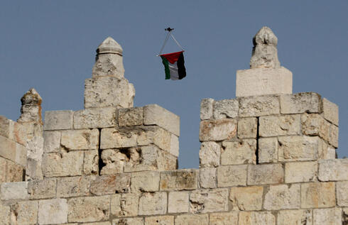 Un dron con una bandera palestina sobrevuela la marcha. 