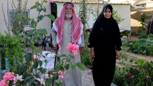 Suleiman y Nazmiya Baraka, padres de una víctima de femicidio, pasean por su jardín. 