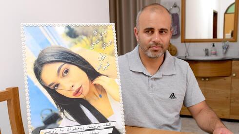 Abbas Abass con una foto de su hija asesinada. 