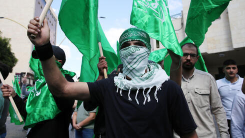 Manifestantes palestinos fieles al movimiento islámico Hamas marchan durante una protesta en la ciudad cisjordana de Hebrón