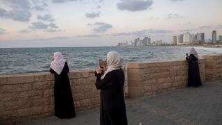 Mujeres árabes sacan fotos al mar en Jaffa. La minoría árabe israelí se vio favorecida por algunas políticas de la coalición política saliente. 
